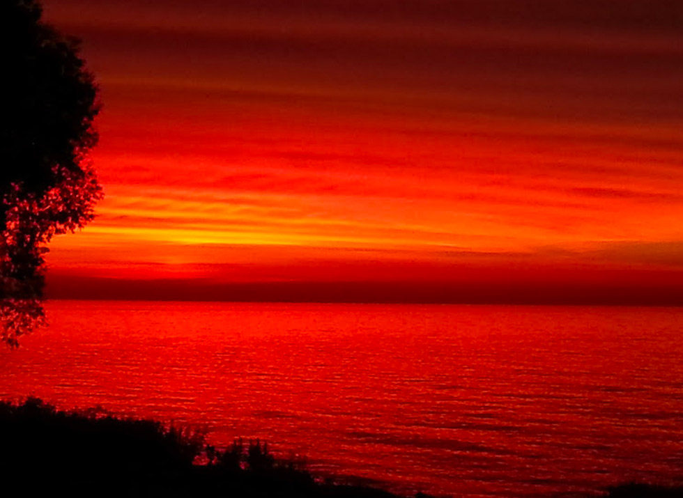 a red sunrise on lake michigan