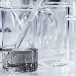 glass beakers of water with a pipet