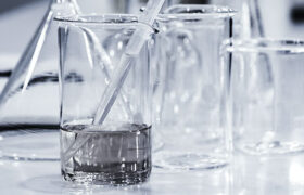 glass beakers of water with a pipet